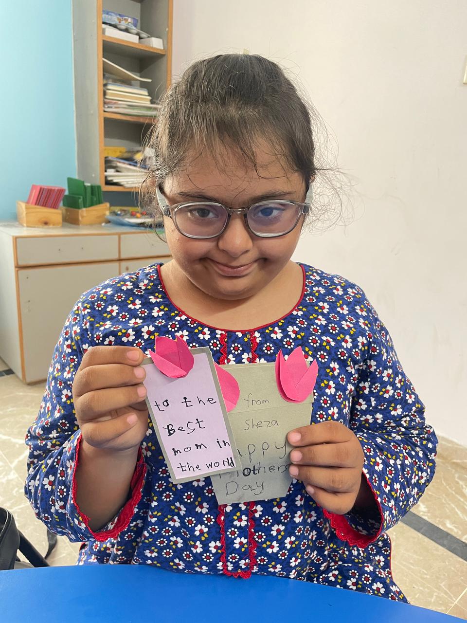 Student proudly sharing a handmade Mother's Day card